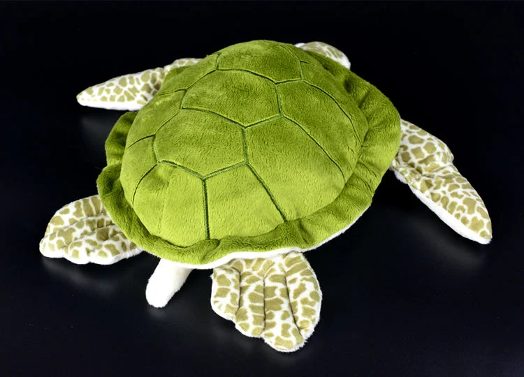 Peluche Tortue Soft sur un lit